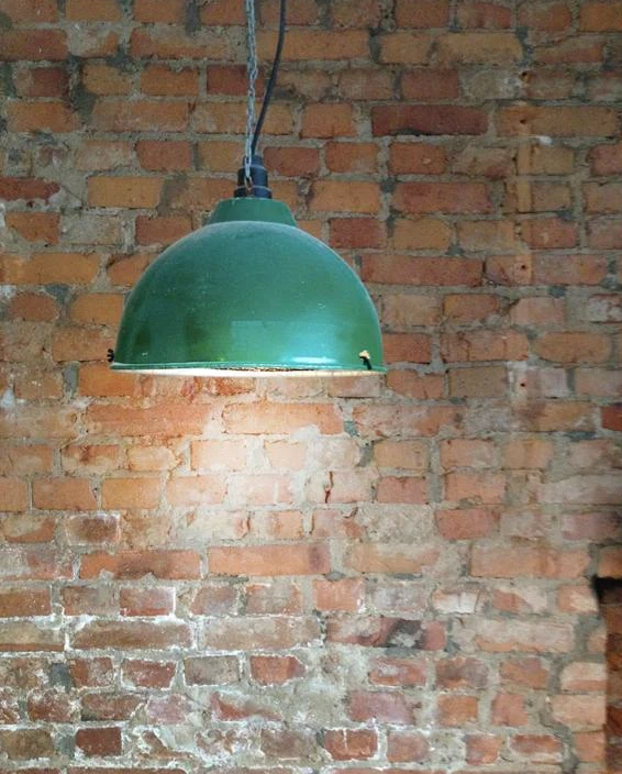 Grön lampa mot tegelväggen på Lilla Ego